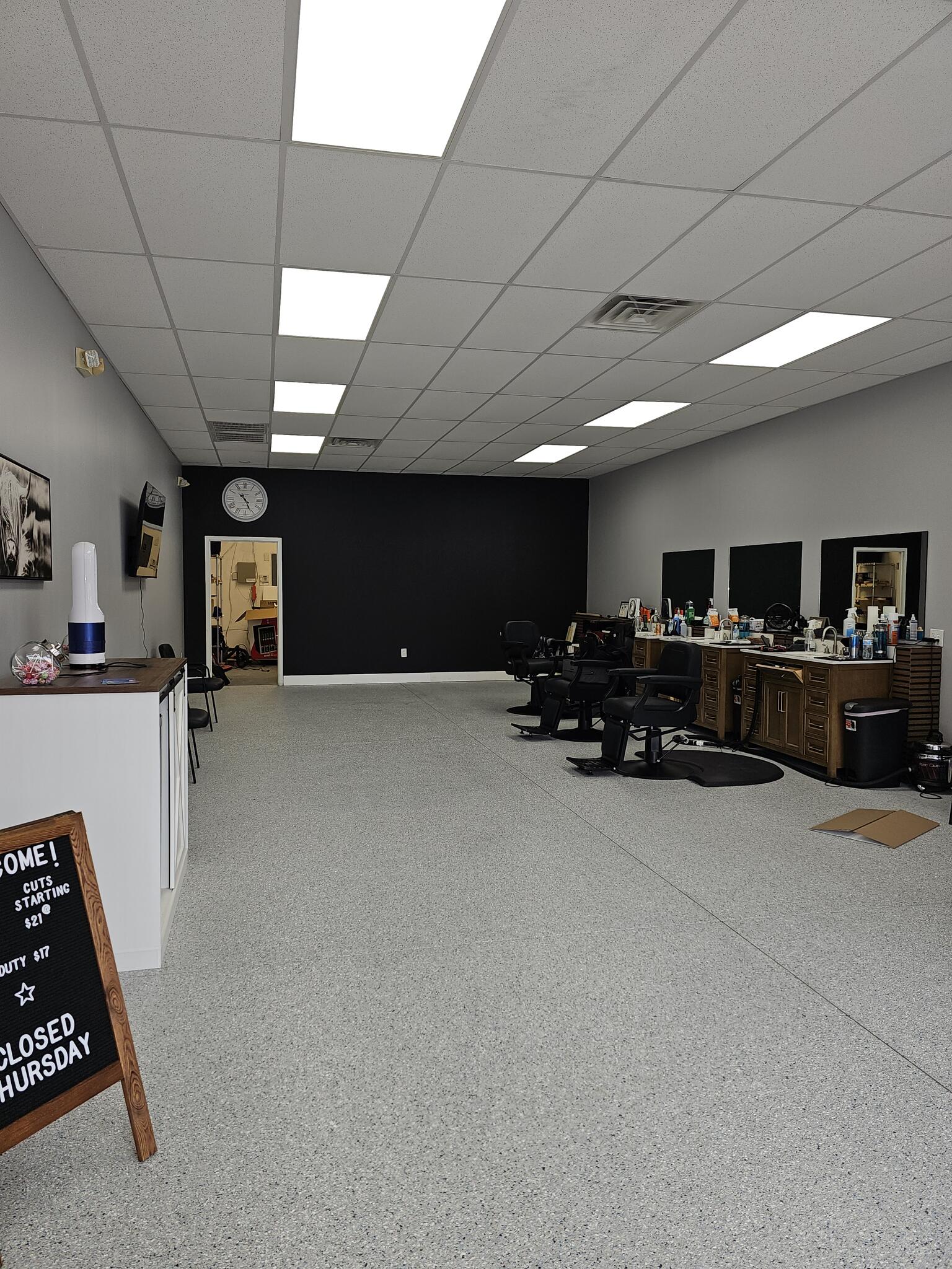 Inside TA Barber Co: barber chairs and mirrors along the right-hand wall